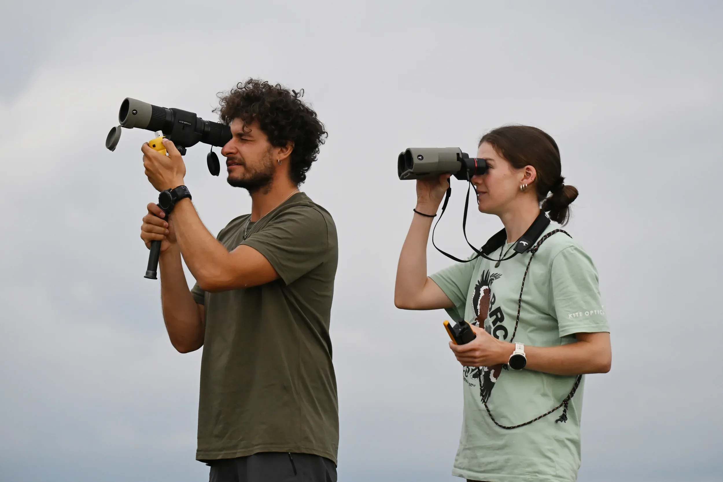 Two counters following the flight with binoculars and a spotting scope
