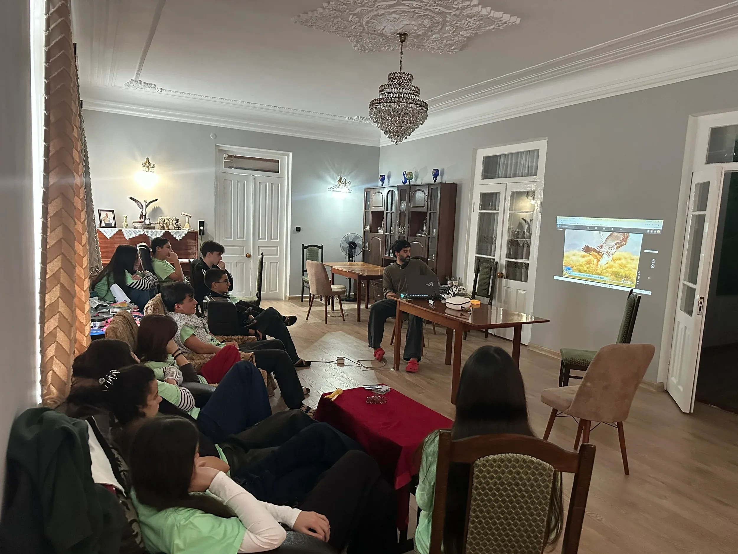 Students watching a projected presentation about birds during camp